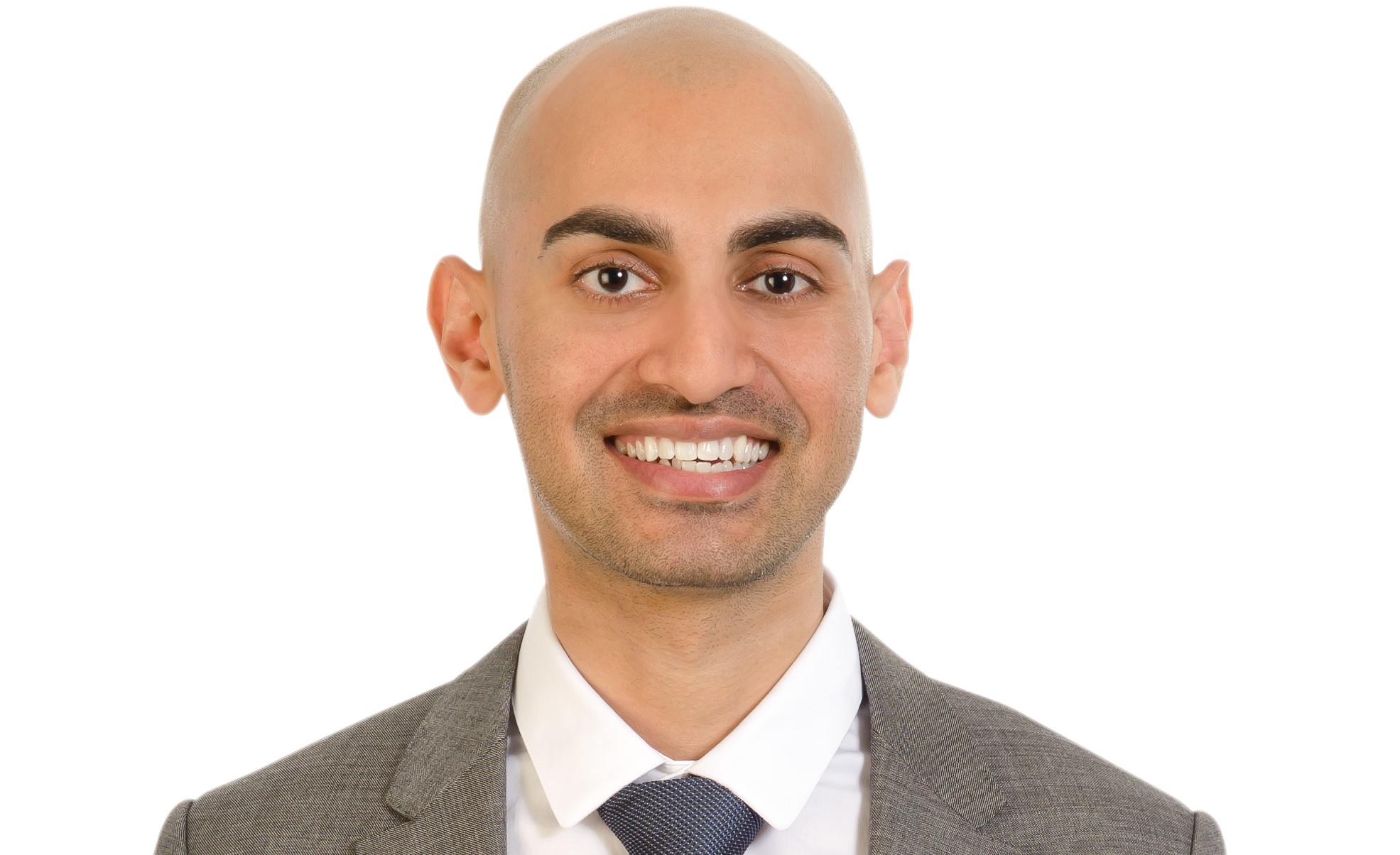 Neil Patel smiling and wearing a brown suit