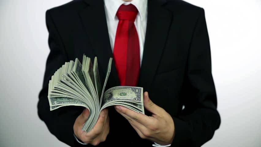 A man in suit holding money
