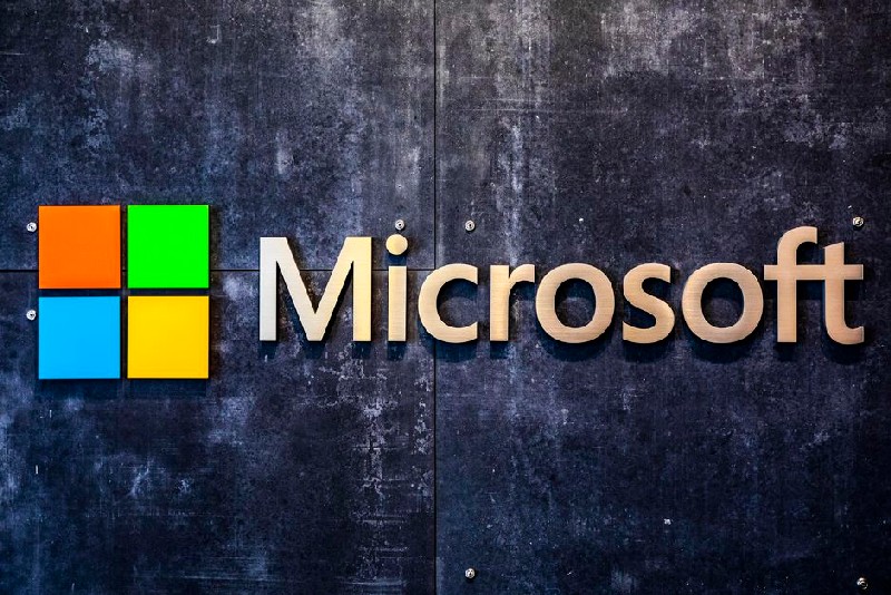 Microsoft logo on a black and grey marble wall