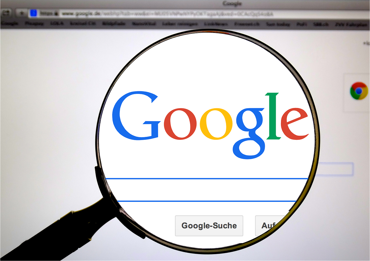 Google search bar and logo in a magnifying glass