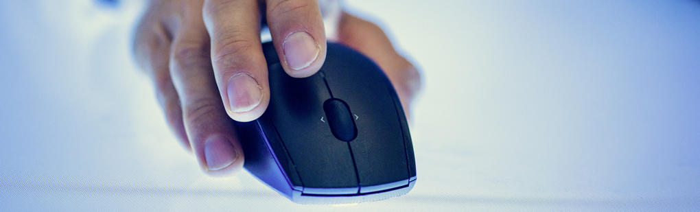 A hand holding a computer mouse