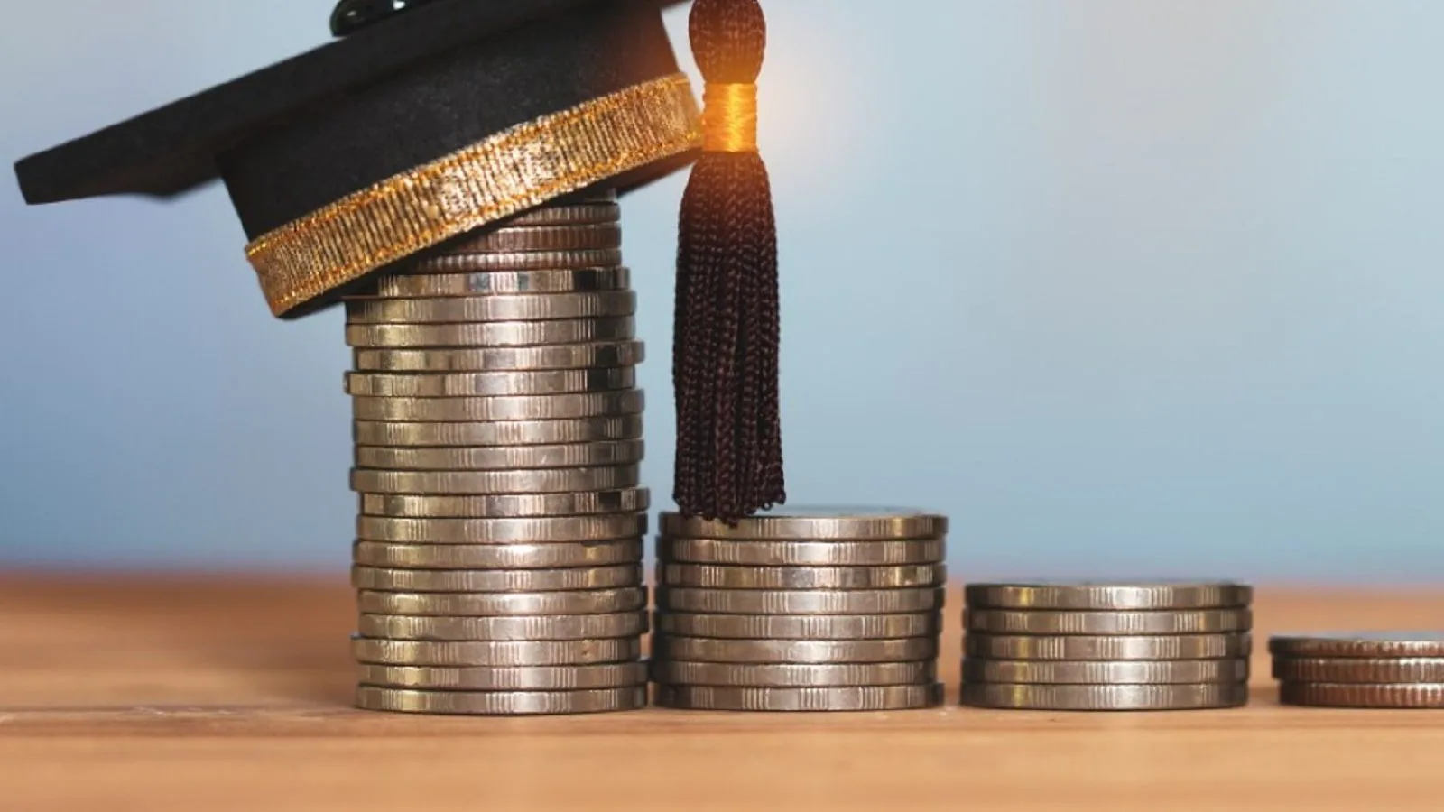 Coins and a mini graduation cap above