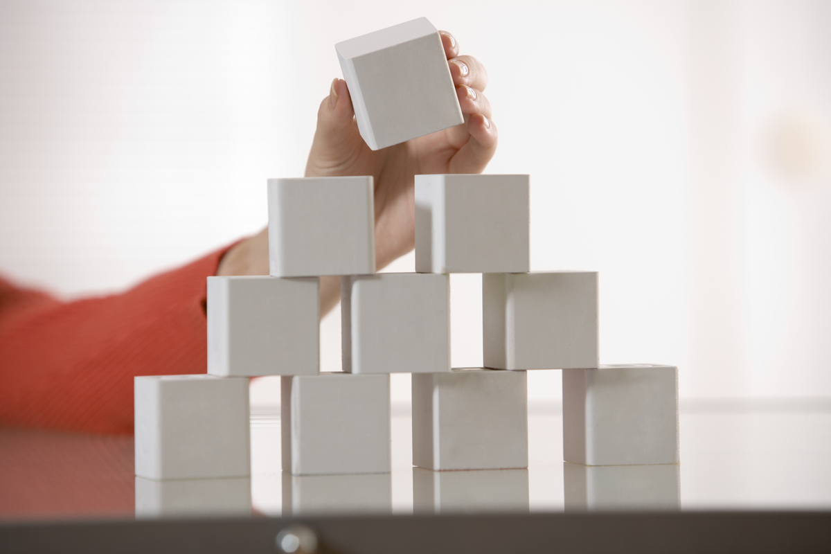 A girl stacking white blocks