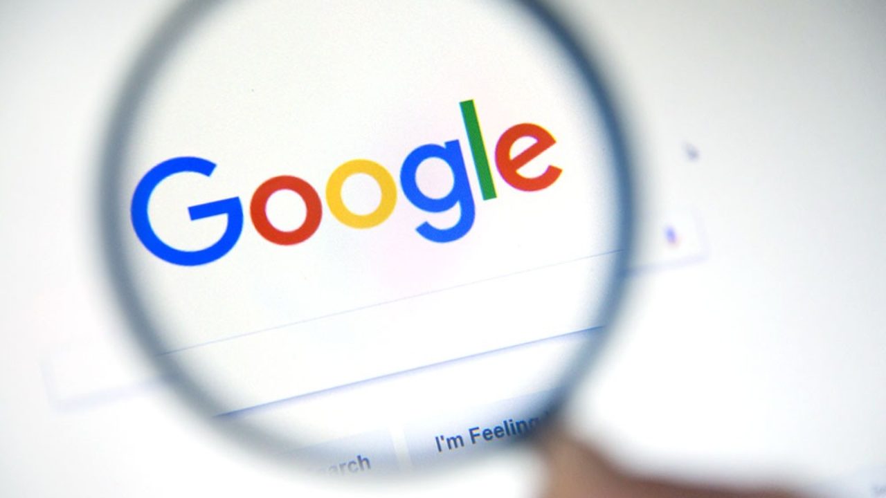 Google search engine and google logo in a magnifying glass