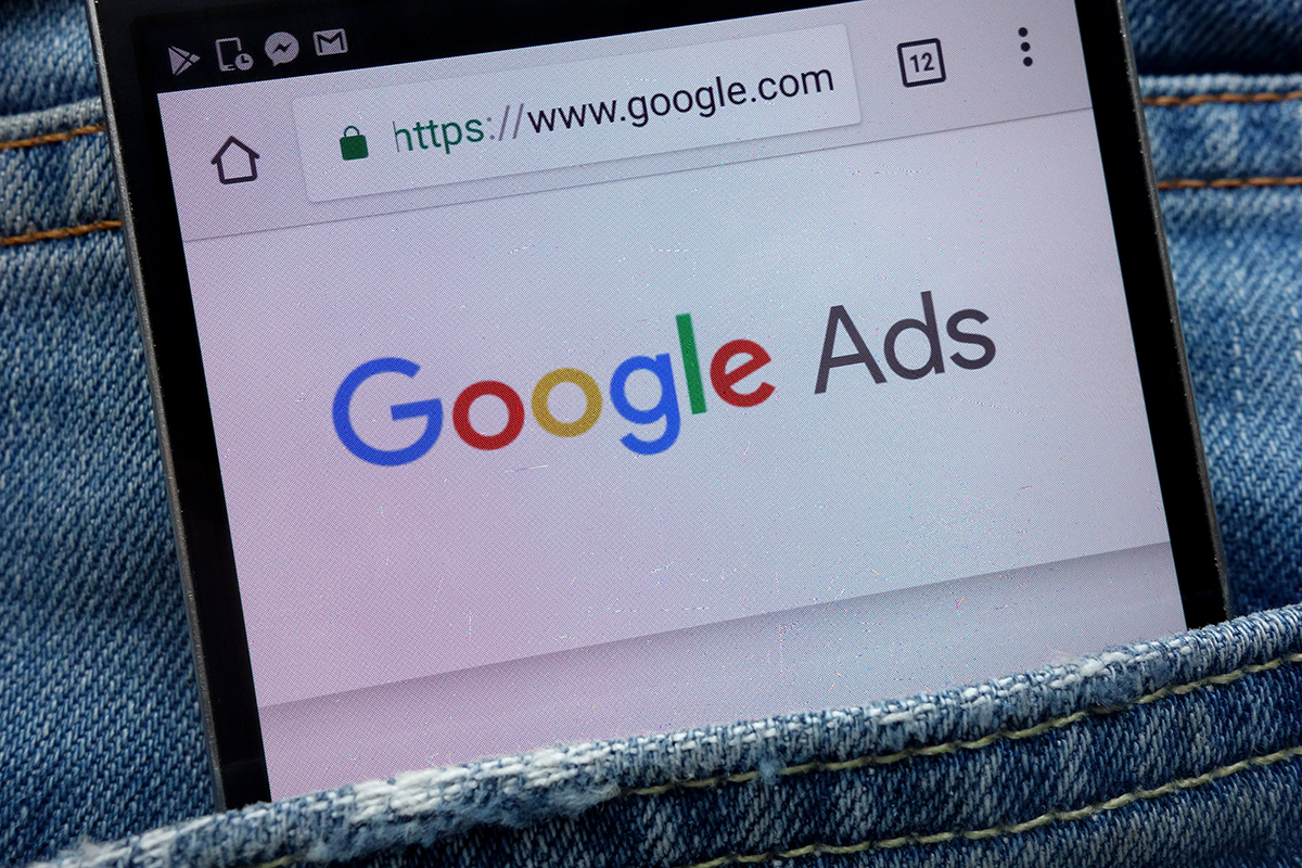 Google ads logo in a phone inside a jeans pocket