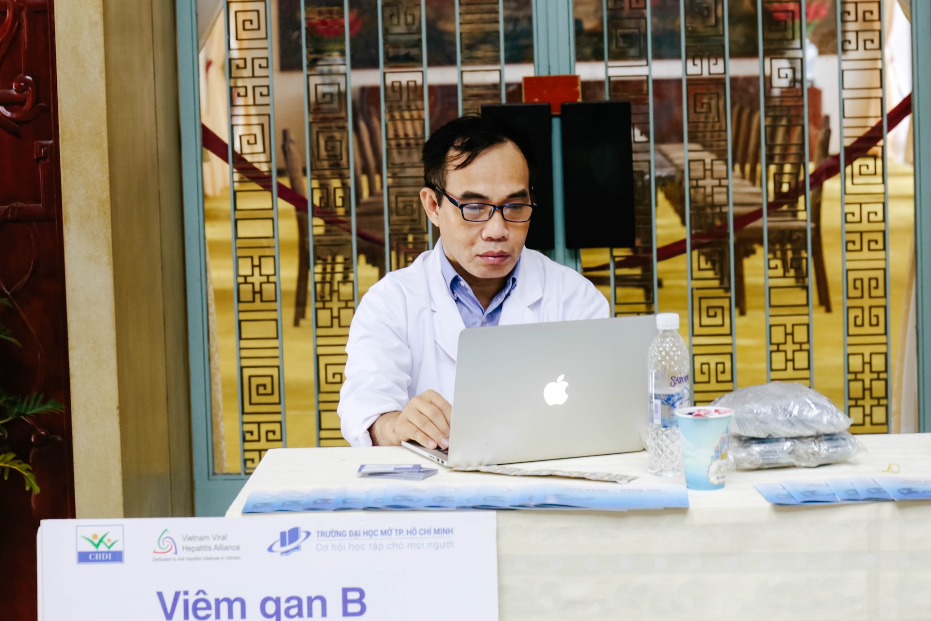 Doctor using a laptop in vietnam