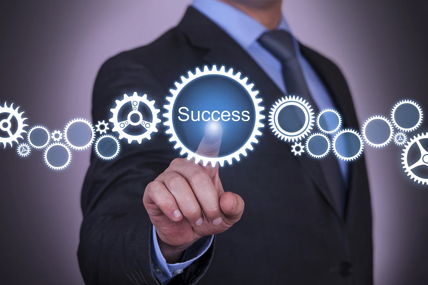 A businessman pointing to the setting logos, which have the word "Success" in the center