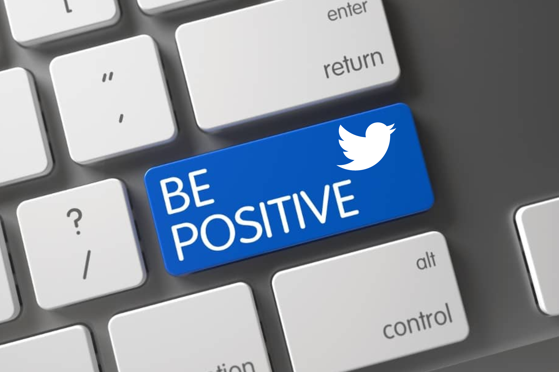 A keyboard with a 'Be Positive' button and the Twitter logo