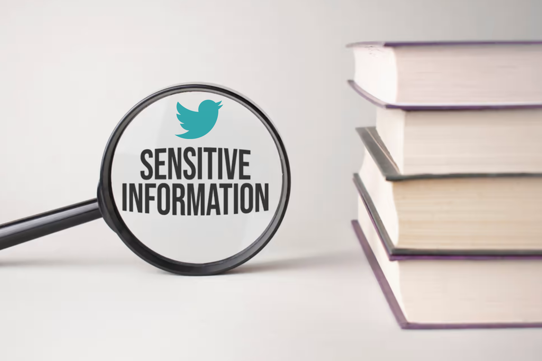 Along with the books, a magnifying glass was focused on the Twitter logo and the words "Sensitive Information"