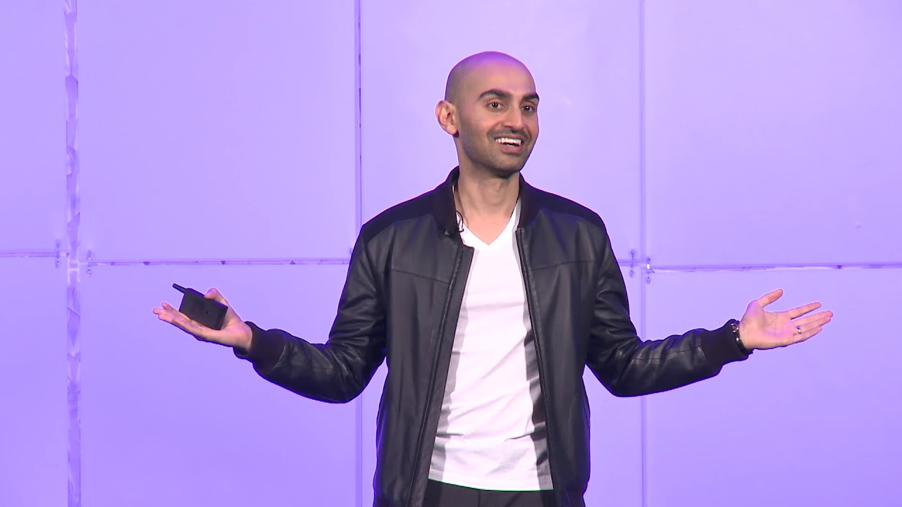 Neil Patel wearing a black leather jacket and white shirt