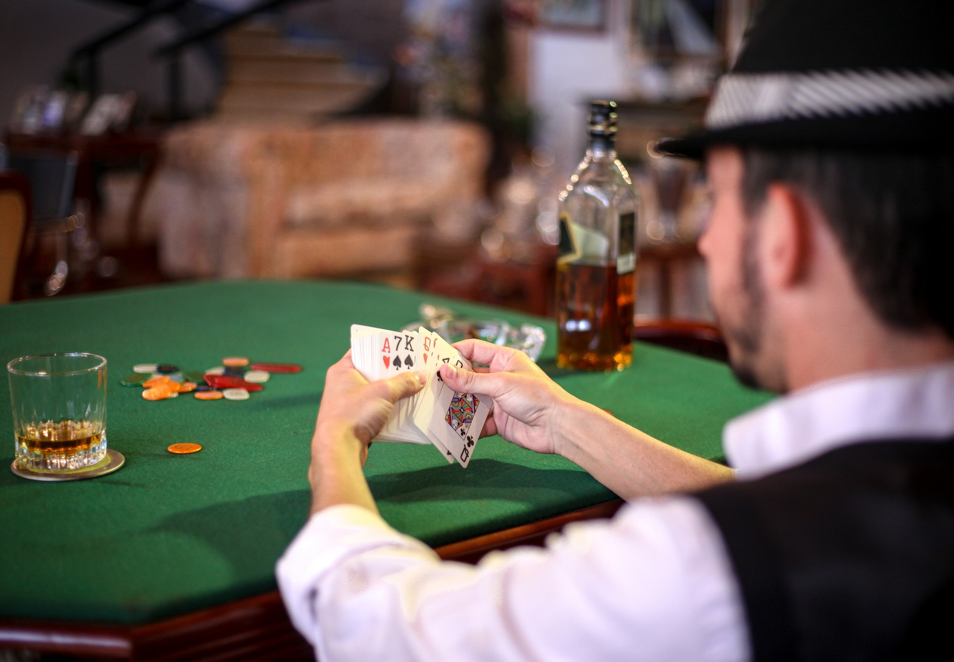 Man playing Poker and drinking