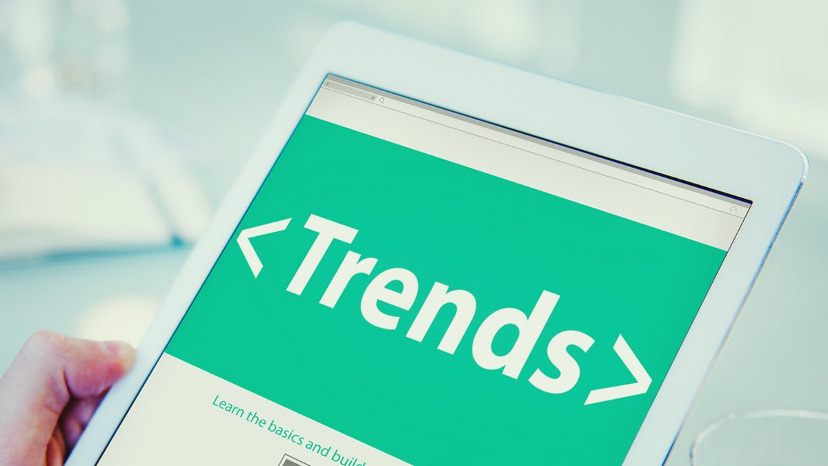 The word "Trends" appears on a tablet's screen