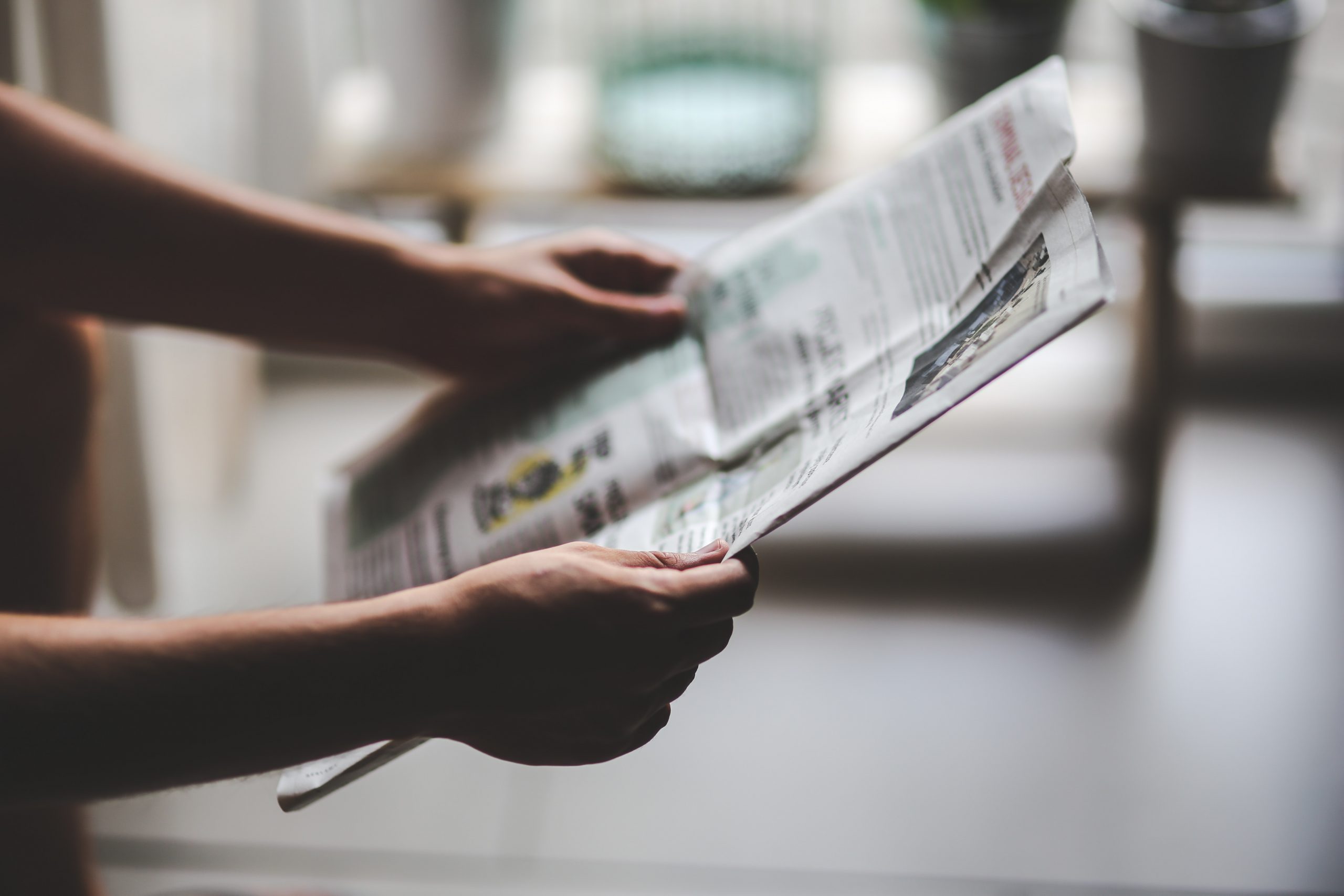 Hands holdding a newspaper