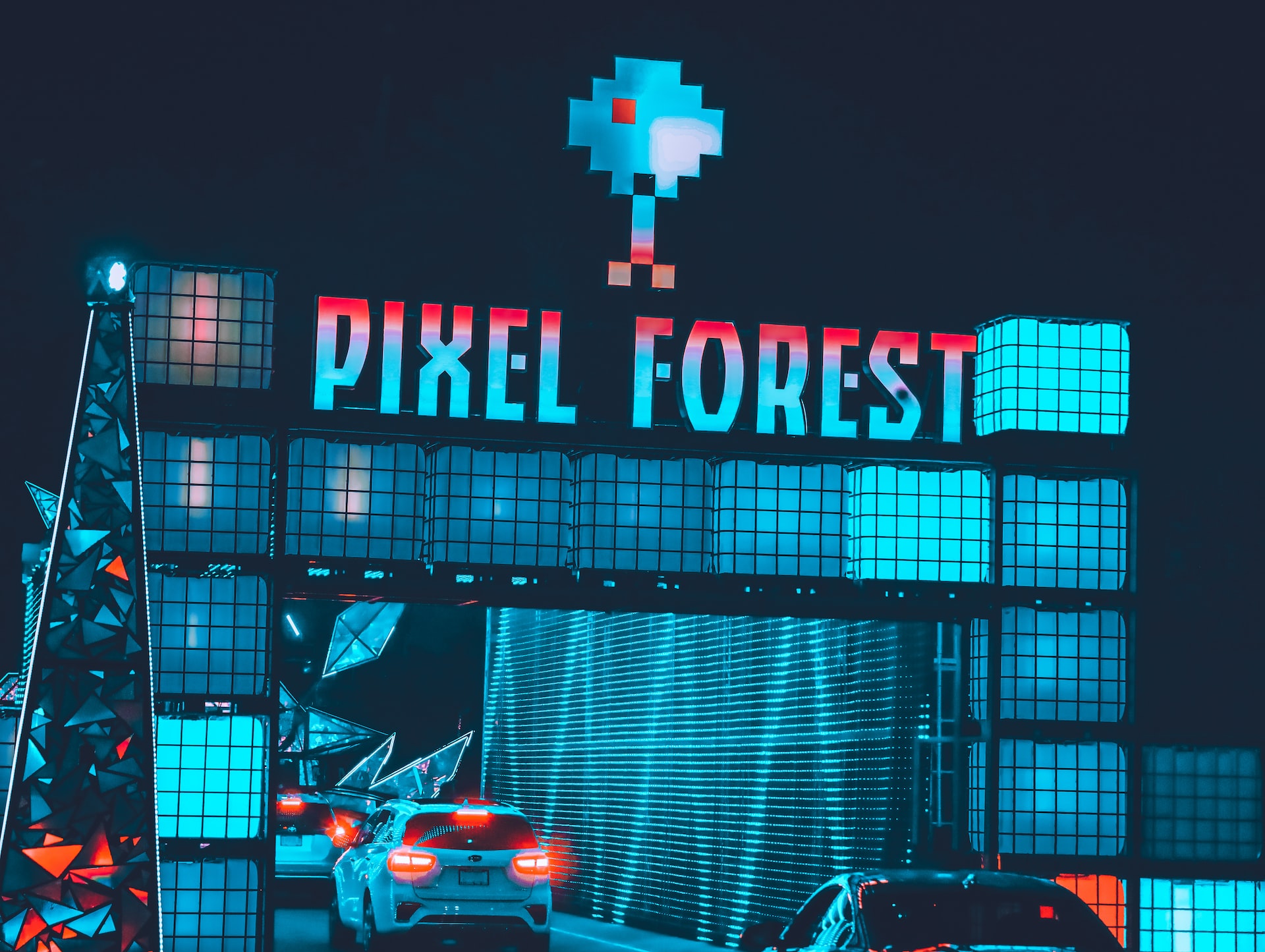 Installation art named pixel forest with cars passing