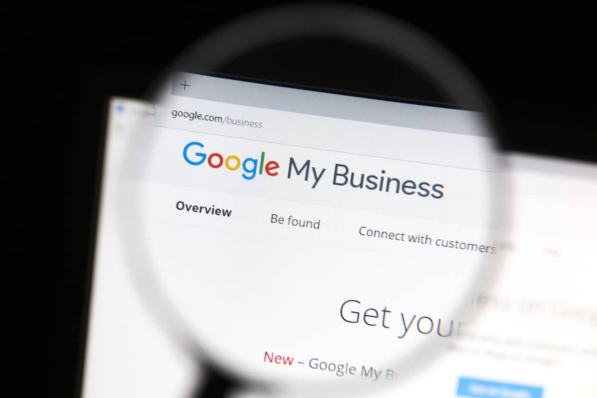 A magnifying glass positioned in front of a "Google My Business" page
