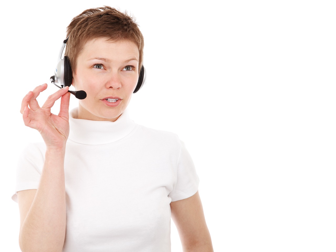Woman with short hair in her white shirt talking to her headset