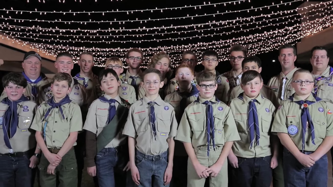 Fifteen members of Boy Scouts of America, with three Scoutmasters on the left and two on the right