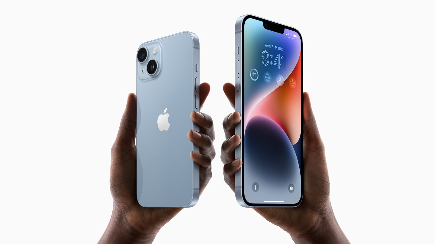 Two hands holding an iphone 14 and iphone 14 plus