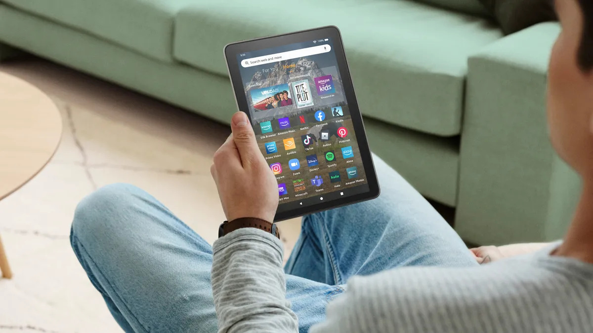 Man Holding A Black Amazon Fire Tablet