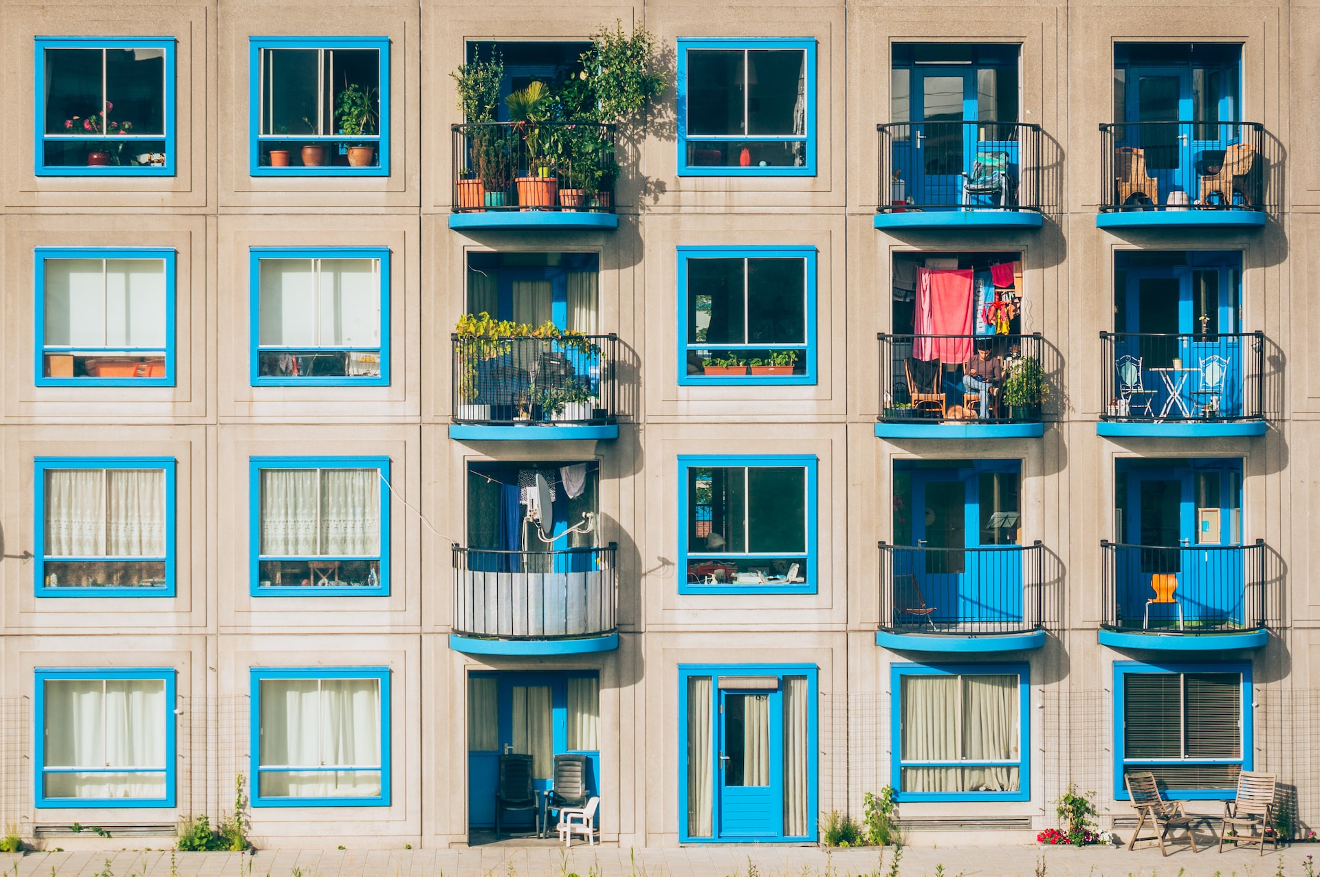 Façade of an apartment building in Amsterdam, with doors and window frames painted in sky blue