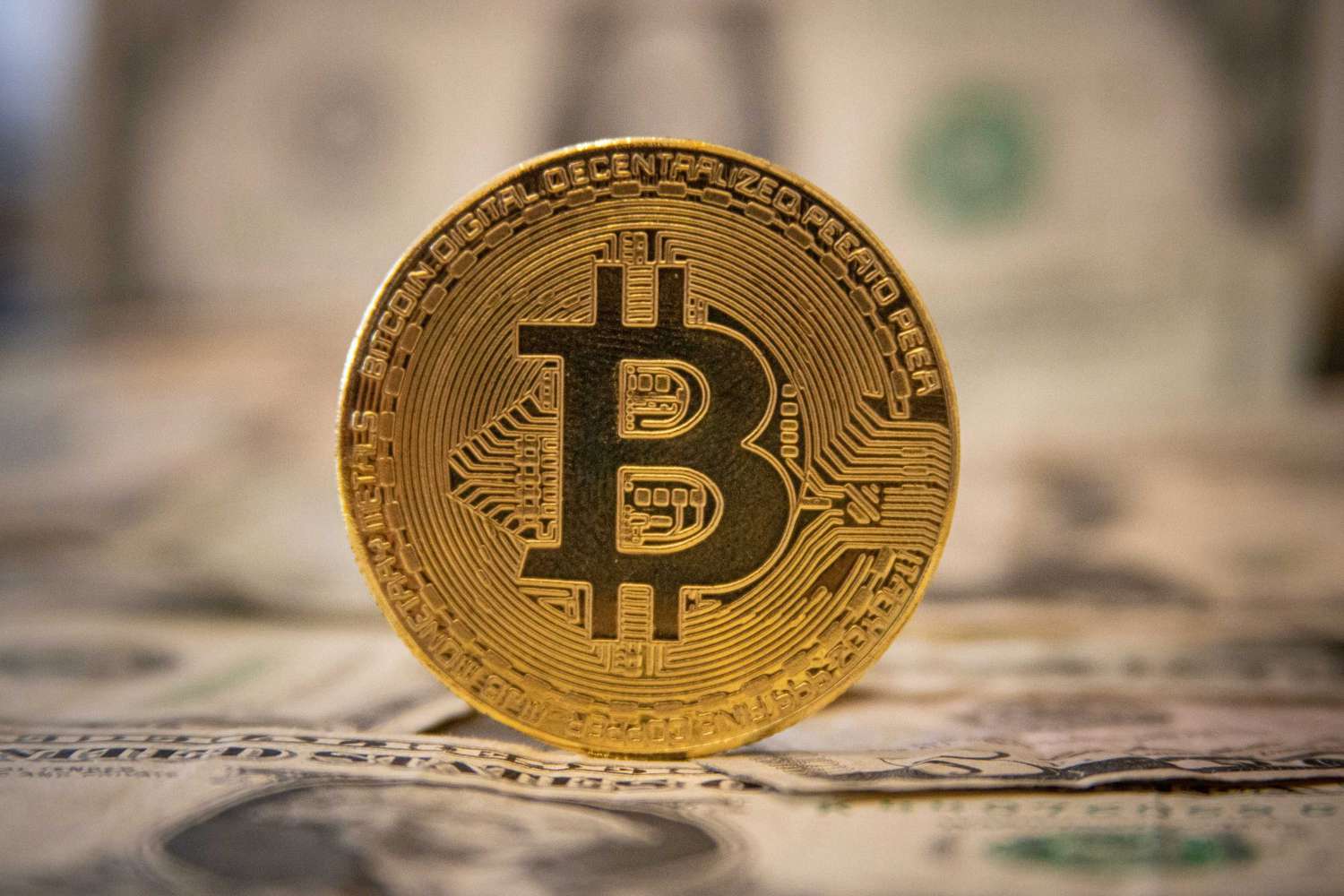 Gold bitcoin on top of money