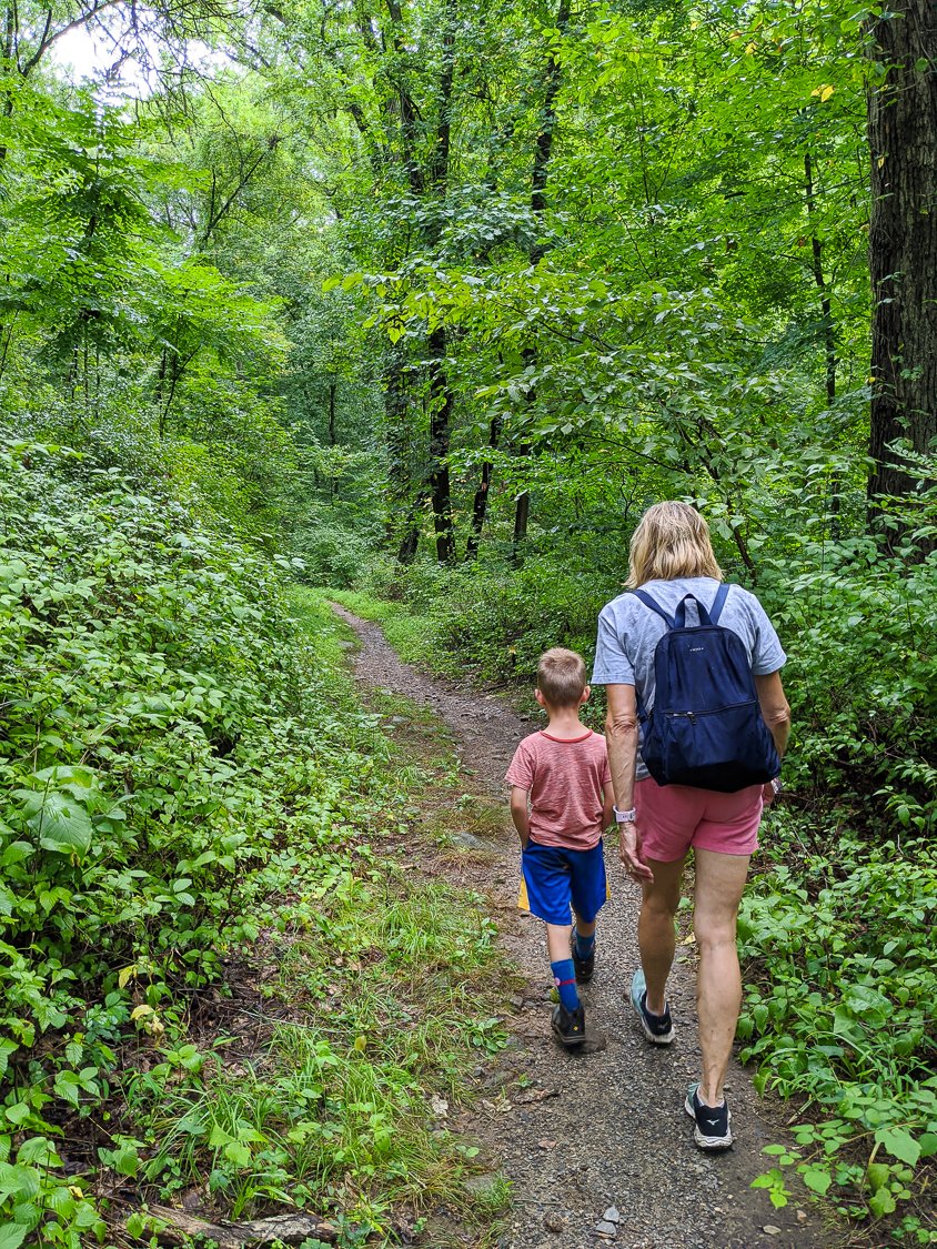 A woman and a child Exploring Local Trails On Foot