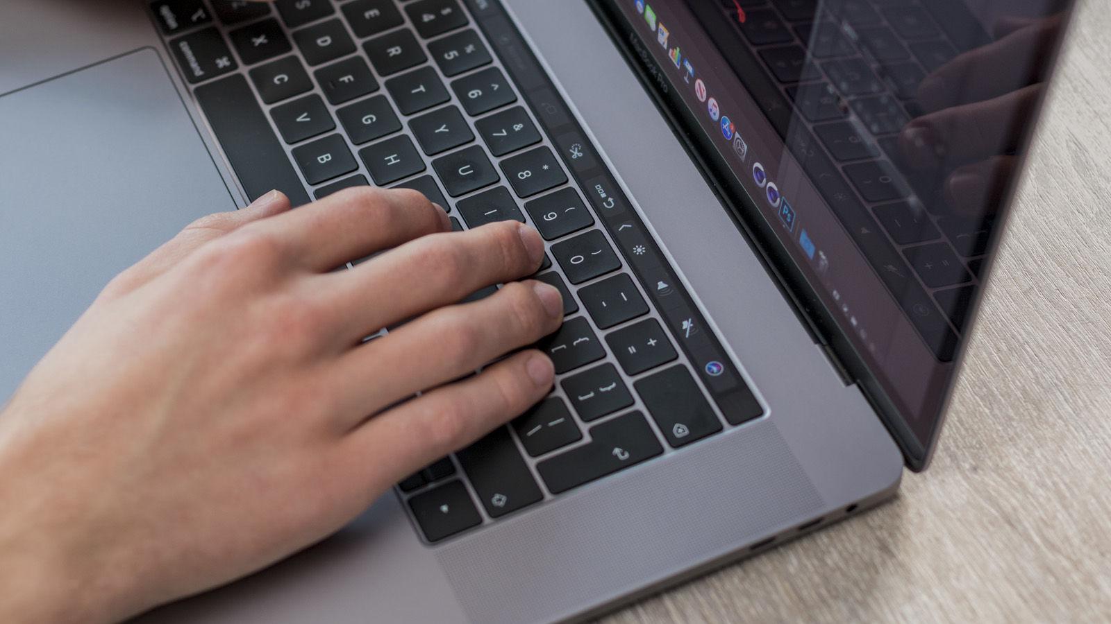 Hands on a gray MacBook