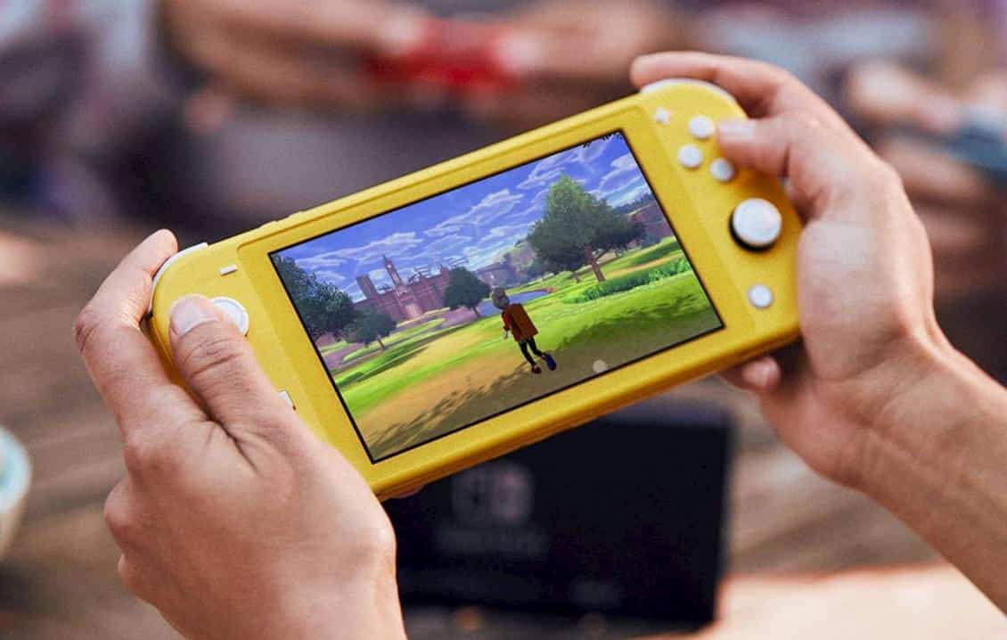 Hands holding a yellow Nintendo switch