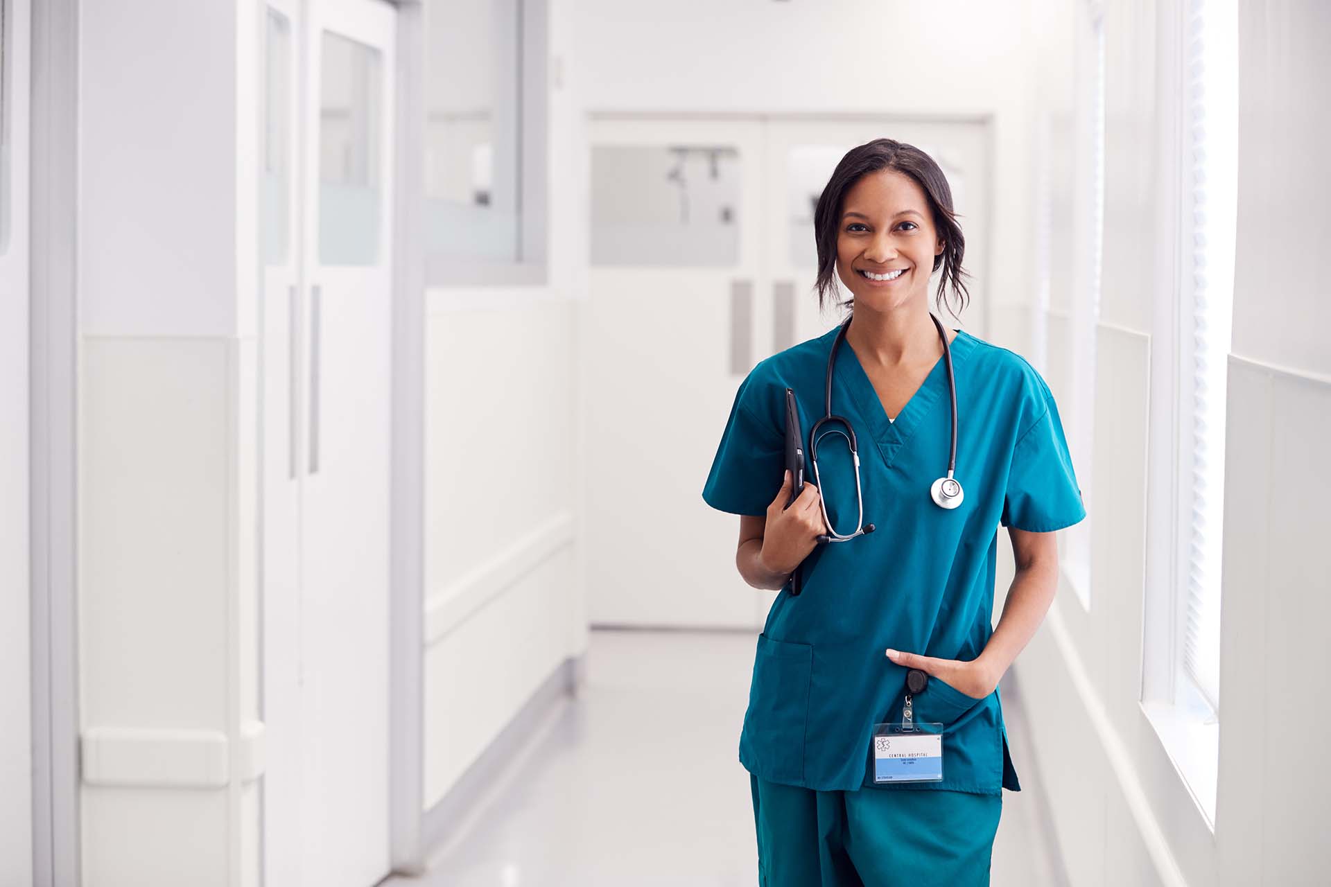 A woman in blue hospital gown with stethoscope