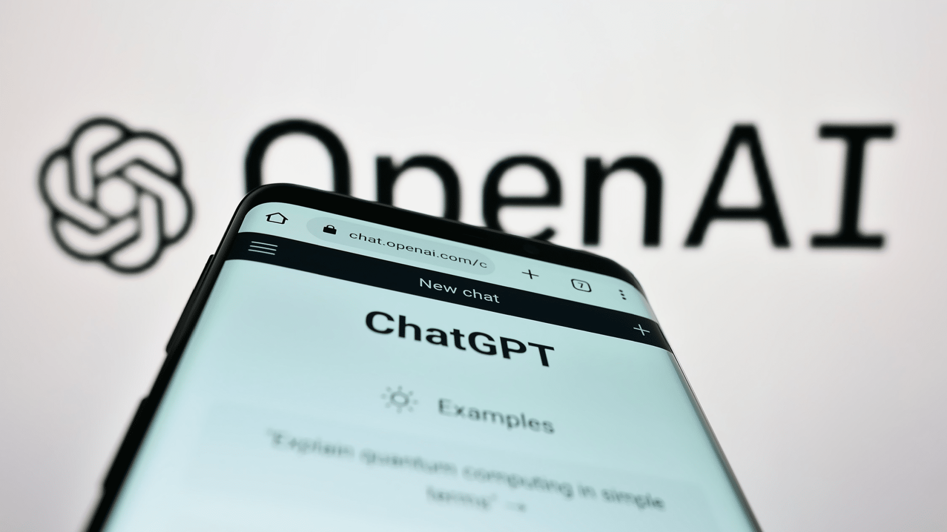 ChatGPT site on a page and OpenAI on the back