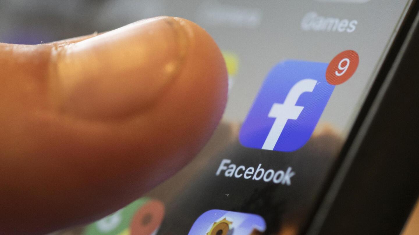 Facebook app logo on a phone