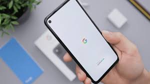 A hand holding a phone with Google logo