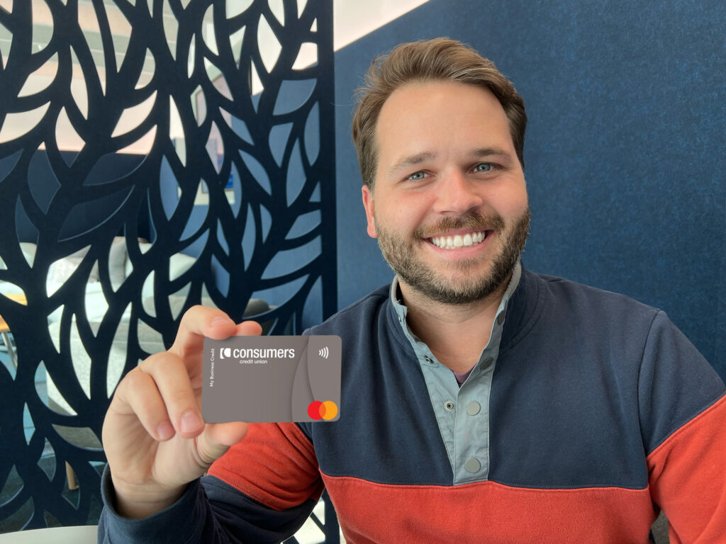 A man showing a business credit card