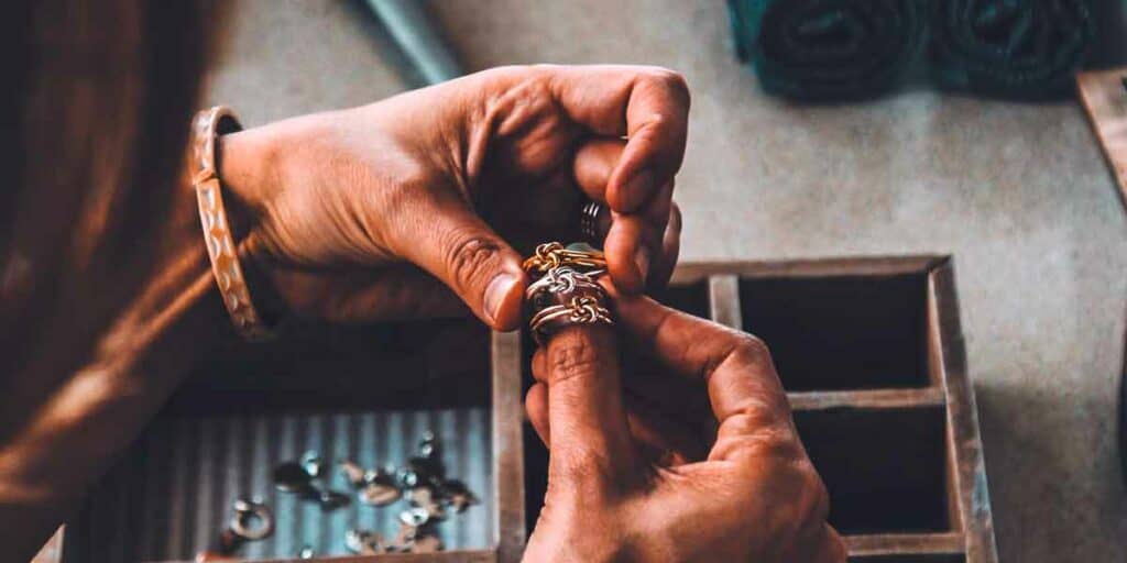 Hands holding handmade rings