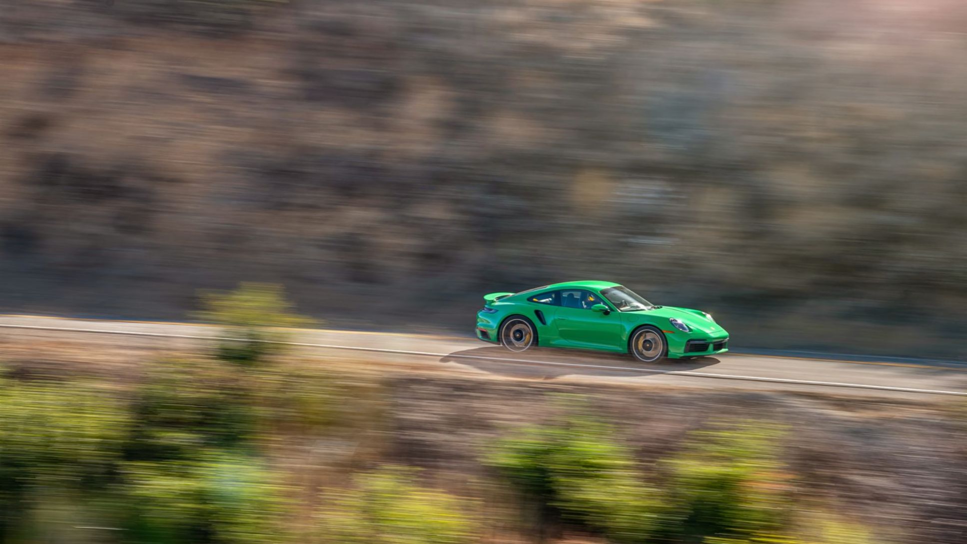 Green sports car running fast on the highway