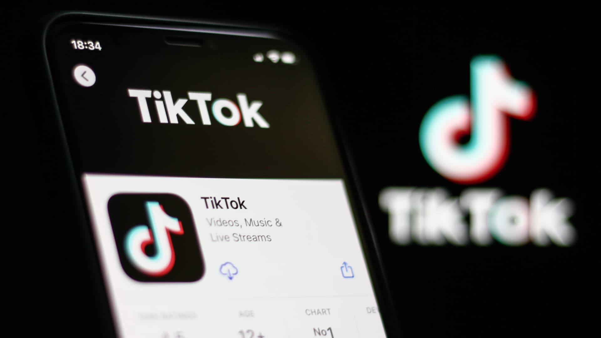 TikTok application on app store and TikTok logo behind