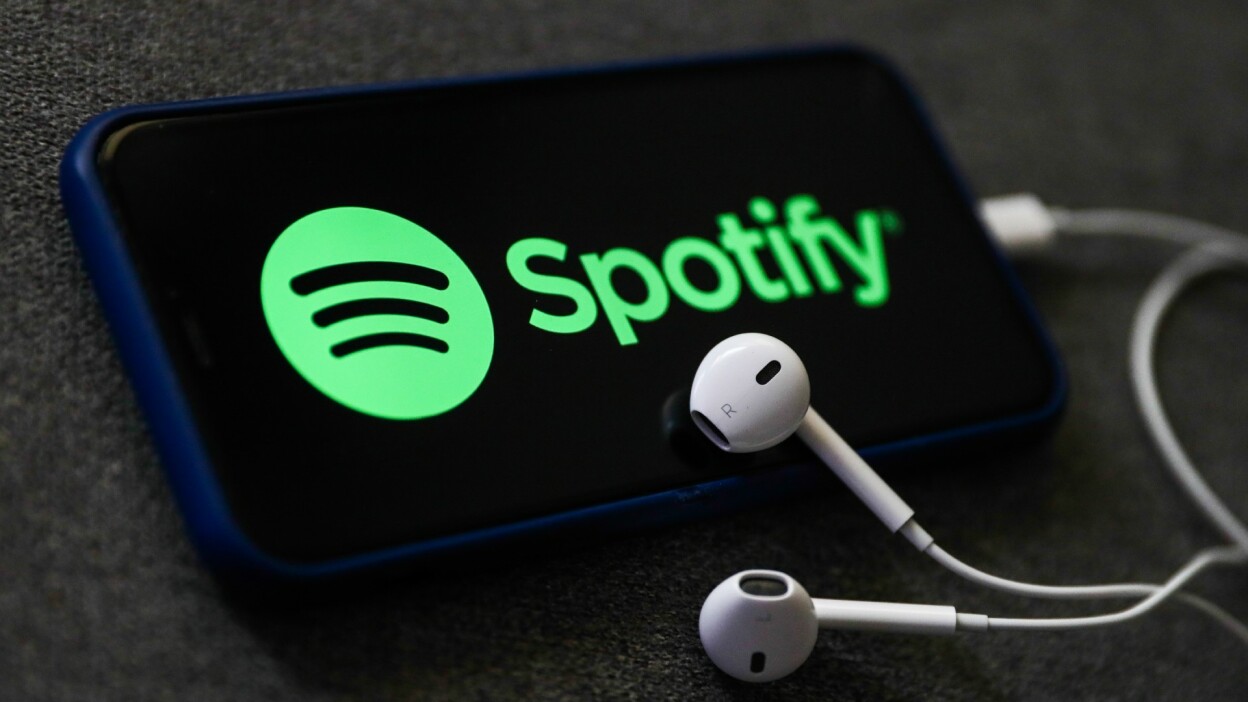 Spotify logo on a phone with earphones