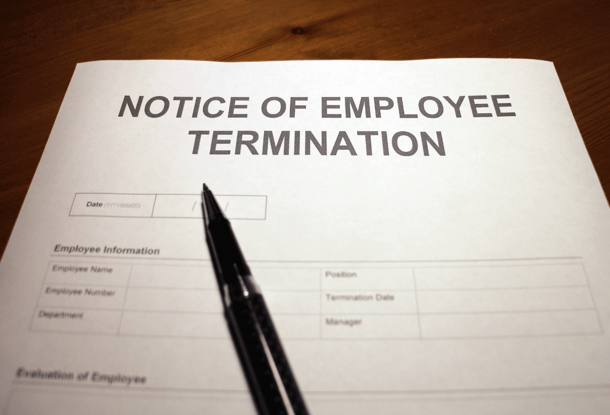 Notice of employee termination paper and a pen